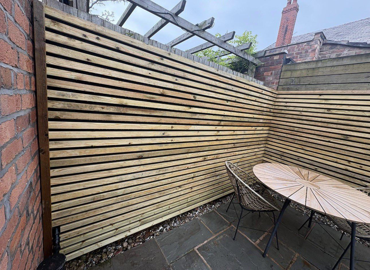 New patio beside a contemporary slatted fence, built by AJ Garden Services in Liverpool