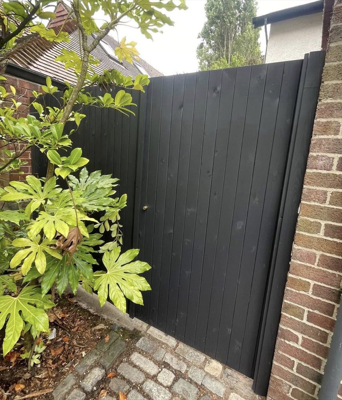 Timber gate and fence painted black by AJ Garden Services in Liverpool