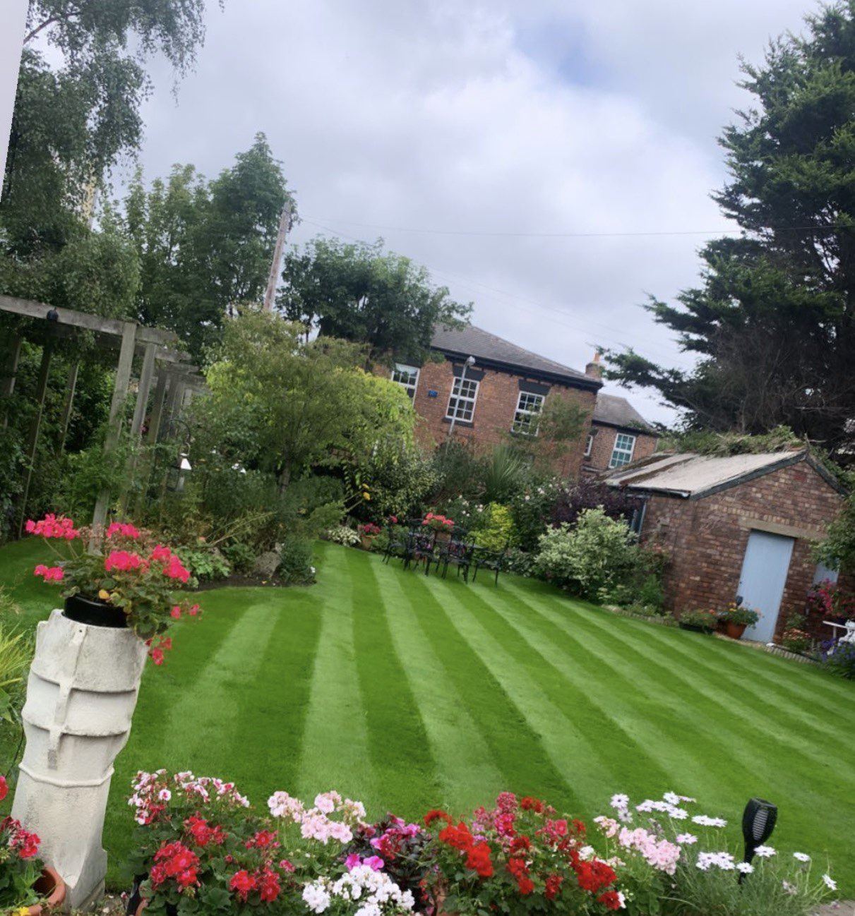 Striped lawn and flower borders maintained by AJ Garden Services in Liverpool